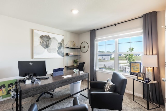 carpeted home office featuring baseboards