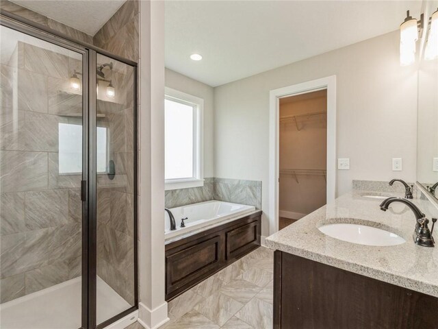 bathroom featuring vanity and plus walk in shower