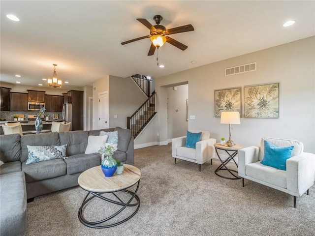 carpeted living room with ceiling fan