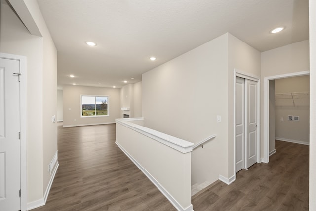 hall with dark wood-type flooring