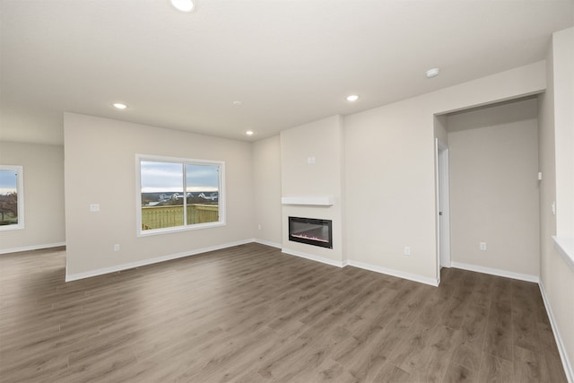 unfurnished living room featuring dark wood-type flooring