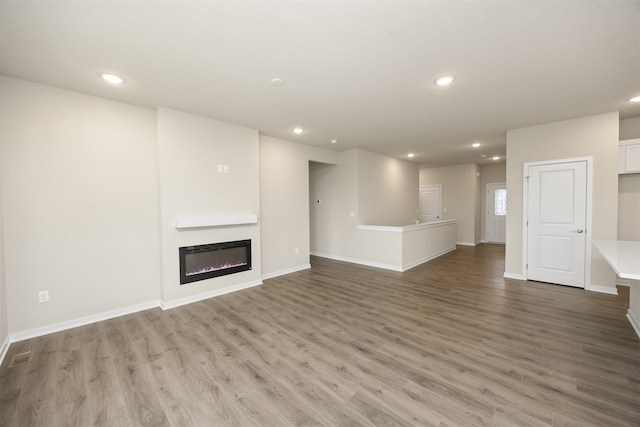 unfurnished living room with hardwood / wood-style flooring