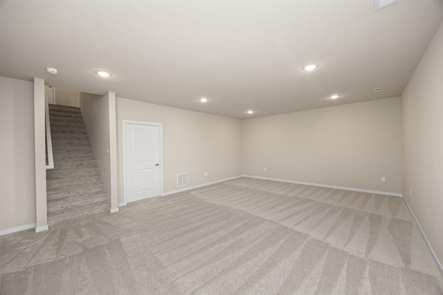 9020 Mockingbird Dr, West Des Moines, IA 50266 - basement featuring light carpet, stairway, baseboards, and recessed lighting