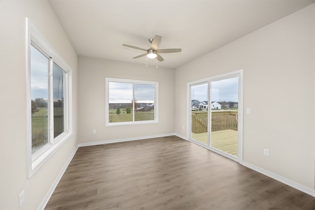 spare room featuring ceiling fan and dark hardwood / wood-style floors