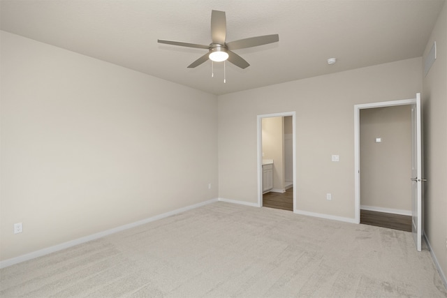 unfurnished bedroom with carpet, ensuite bath, and ceiling fan