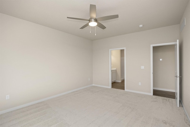 9020 Mockingbird Dr, West Des Moines, IA 50266 - unfurnished bedroom featuring carpet flooring, baseboards, ensuite bathroom, and ceiling fan