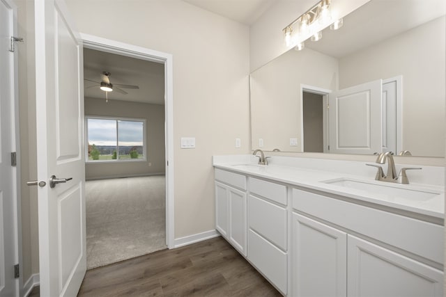 bathroom with ceiling fan, wood-type flooring, and vanity