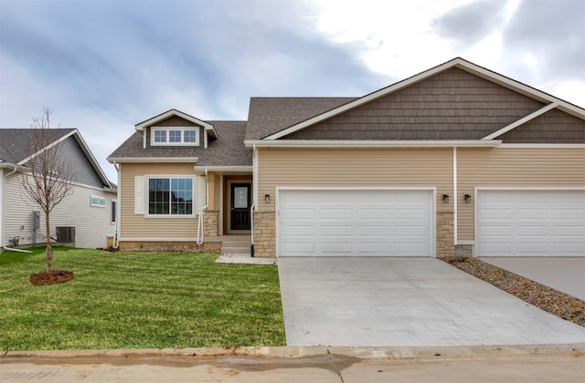 craftsman inspired home featuring central AC, a garage, and a front lawn