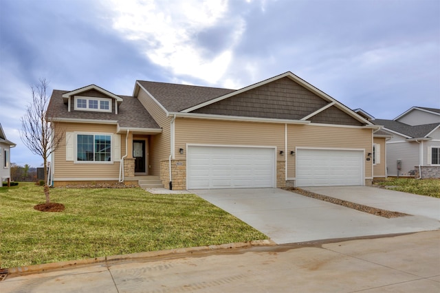 craftsman house with a garage and a front lawn