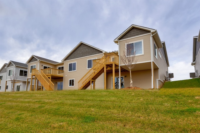 back of property featuring a deck and a yard