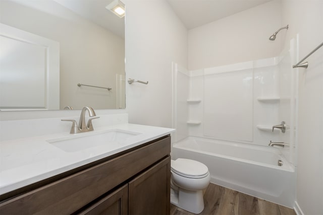 full bathroom featuring hardwood / wood-style floors, vanity, toilet, and bathtub / shower combination