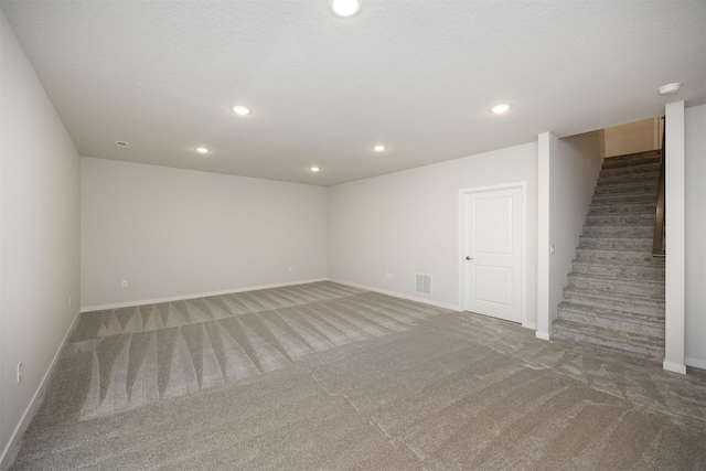 9042 Mockingbird Dr, West Des Moines, IA 50266 - finished basement featuring carpet flooring, baseboards, stairway, and recessed lighting