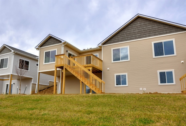 back of property with a lawn and a wooden deck