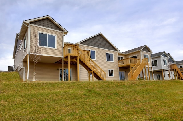 rear view of property featuring central air condition unit, a lawn, and a deck