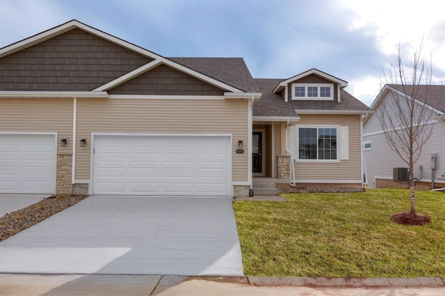 9042 Mockingbird Dr, West Des Moines, IA 50266 - view of front of house featuring concrete driveway, central AC, a front lawn, a shingled roof, and stone siding
