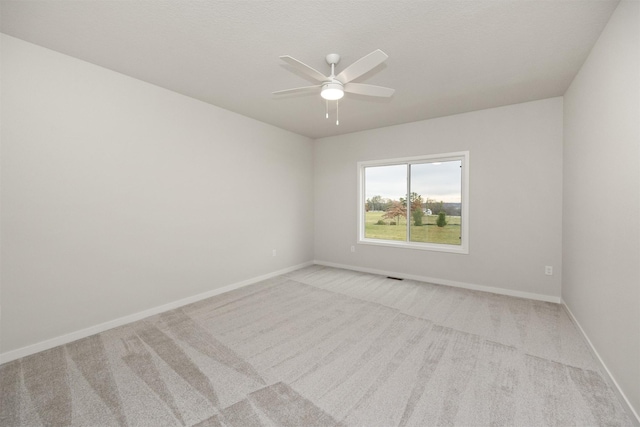9042 Mockingbird Dr, West Des Moines, IA 50266 - unfurnished room featuring light colored carpet, ceiling fan, and baseboards
