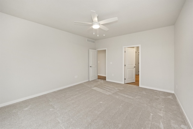 spare room featuring ceiling fan and light colored carpet