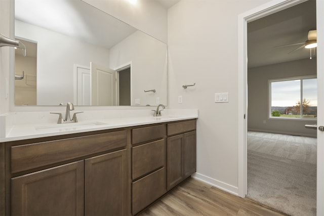 bathroom with vanity, ceiling fan, and wood-type flooring