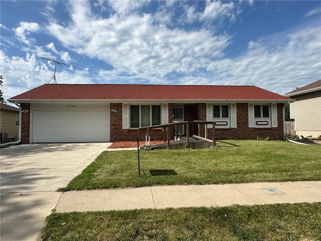 single story home featuring a garage and a front yard