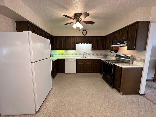 kitchen featuring dark brown cabinetry, ceiling fan, sink, a textured ceiling, and white appliances