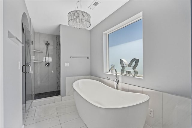 full bath featuring visible vents, a soaking tub, a shower stall, and tile patterned flooring