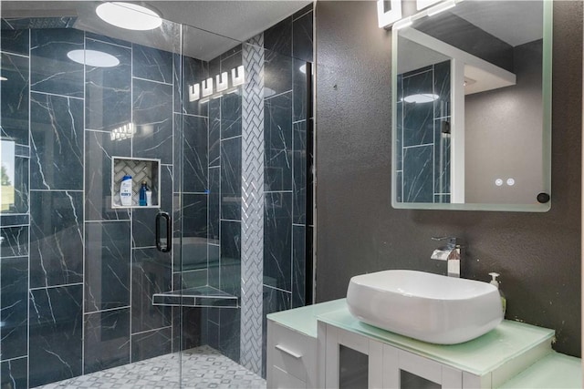 full bathroom featuring vanity and a shower stall