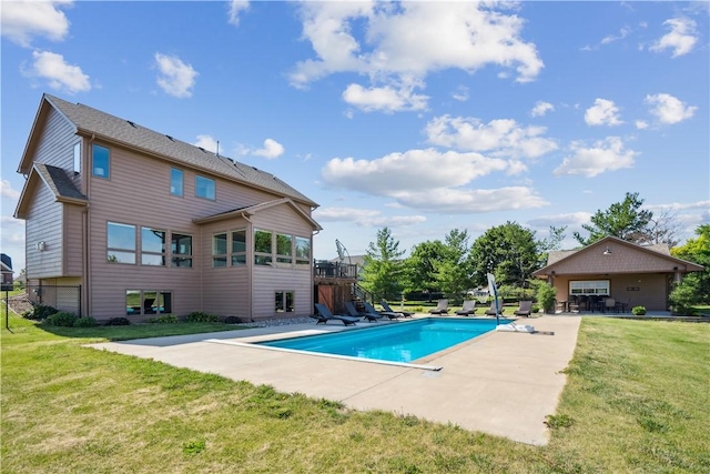 view of swimming pool featuring a yard and a patio