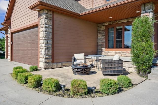 view of patio featuring a fire pit and a garage