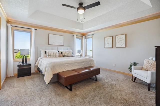 bedroom featuring carpet, ceiling fan, and a raised ceiling