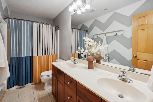 full bathroom featuring vanity, shower / bath combination with curtain, tile patterned flooring, toilet, and a textured ceiling