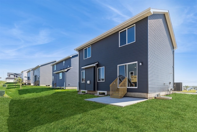 rear view of house with a yard, central AC unit, and a patio area