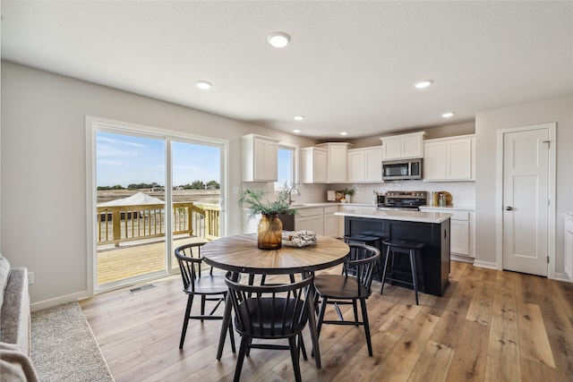 dining room featuring light hardwood / wood-style floors and sink