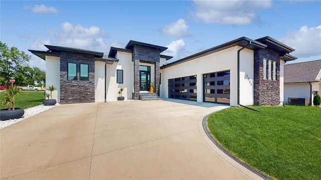 contemporary home with stucco siding, an attached garage, stone siding, driveway, and a front lawn