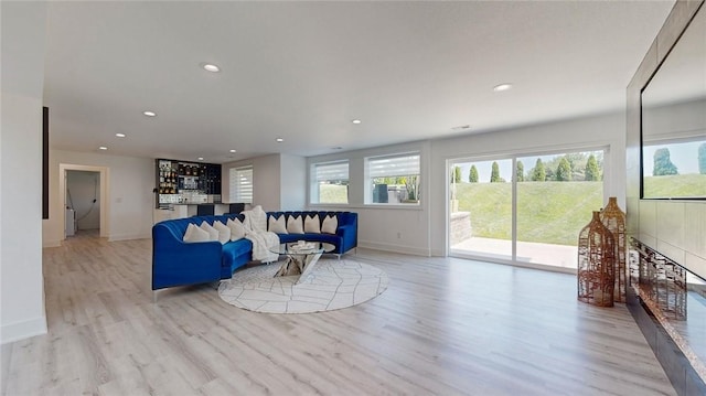 living area with light wood-type flooring, a wealth of natural light, and recessed lighting