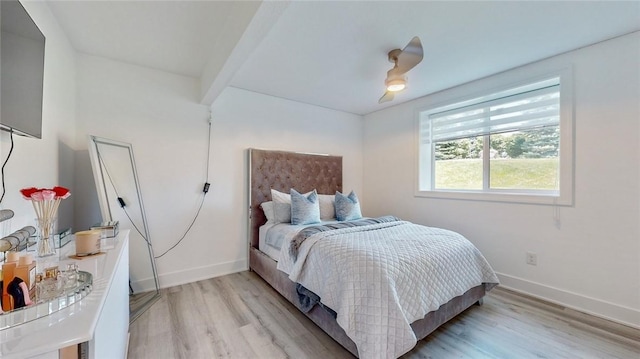 bedroom with light wood-type flooring, baseboards, and a ceiling fan