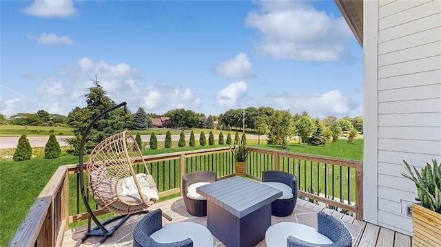 wooden deck with a yard and a rural view