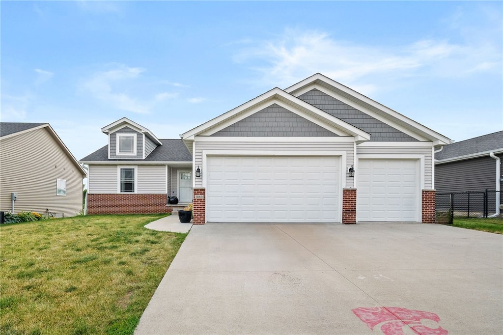 craftsman-style home with a garage and a front lawn