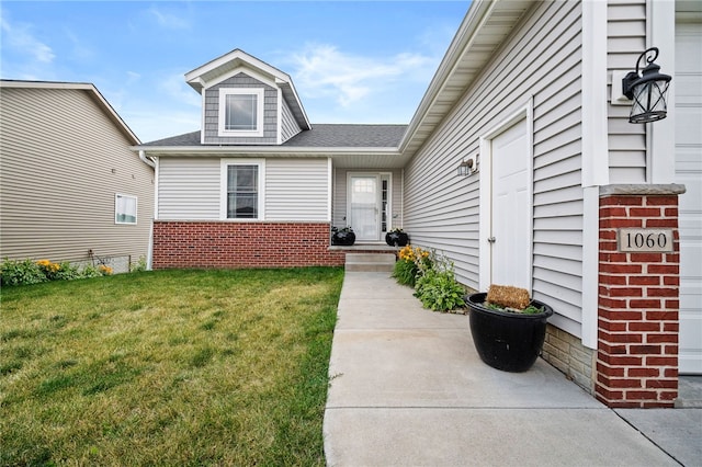 entrance to property with a lawn