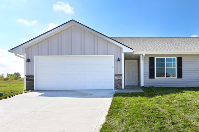 ranch-style house with a garage, board and batten siding, concrete driveway, and a front yard