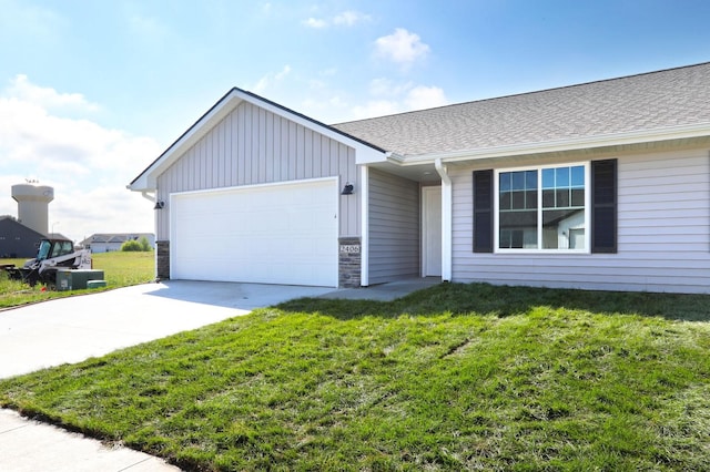 ranch-style home with a shingled roof, an attached garage, driveway, and a front lawn