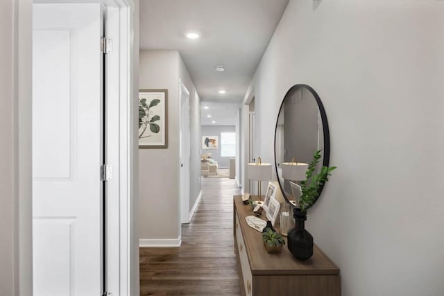 hall featuring recessed lighting, baseboards, and wood finished floors