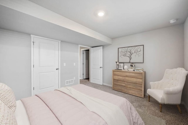 carpeted bedroom featuring baseboards and visible vents