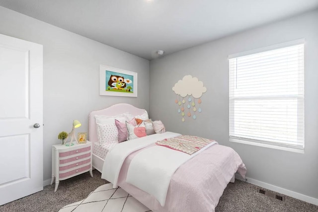 bedroom with multiple windows, baseboards, visible vents, and light carpet