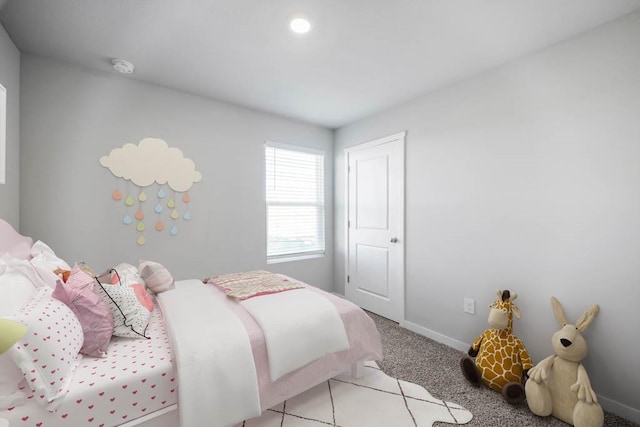 bedroom featuring baseboards and light carpet