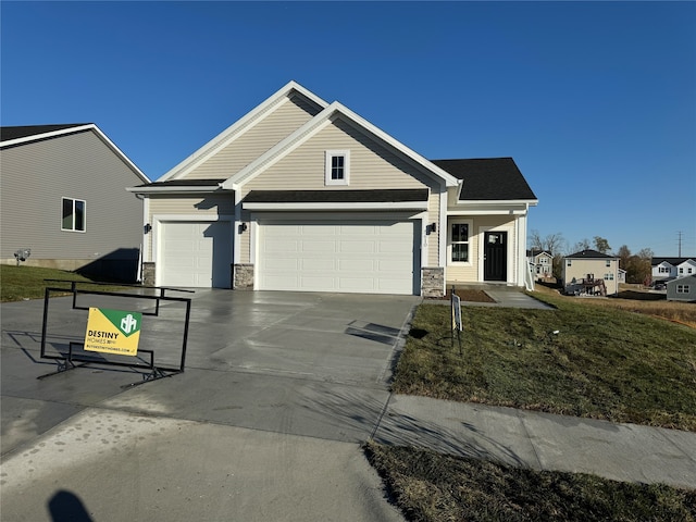 view of front of property featuring a front yard and a garage