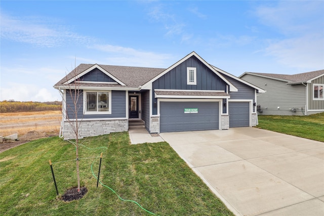 view of front of property with a front yard and a garage