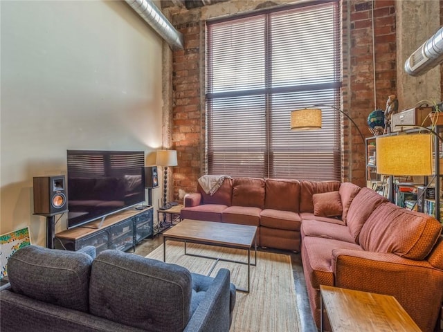 living area featuring brick wall