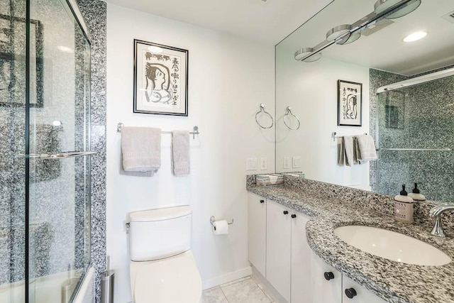 bathroom featuring tile patterned floors, vanity, walk in shower, and toilet