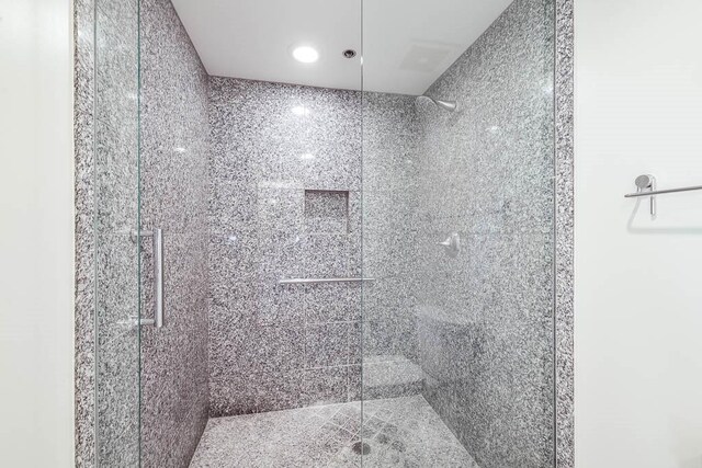 bathroom with tiled shower