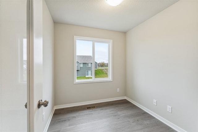 unfurnished room with light hardwood / wood-style flooring